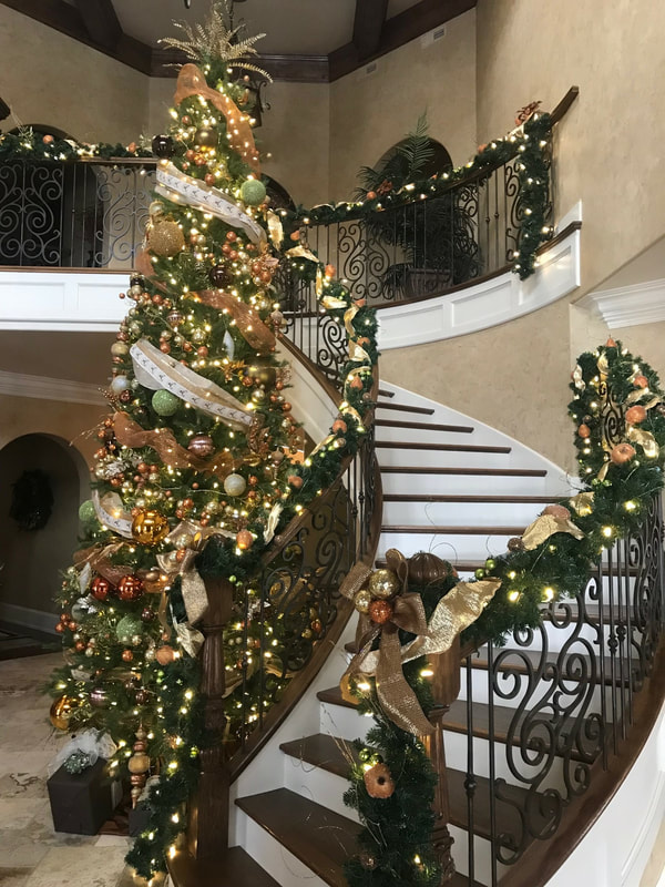 close up of interior stairway decorated with lights on bannister