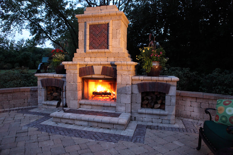 backyard fireplace and chimney in action at dusk
