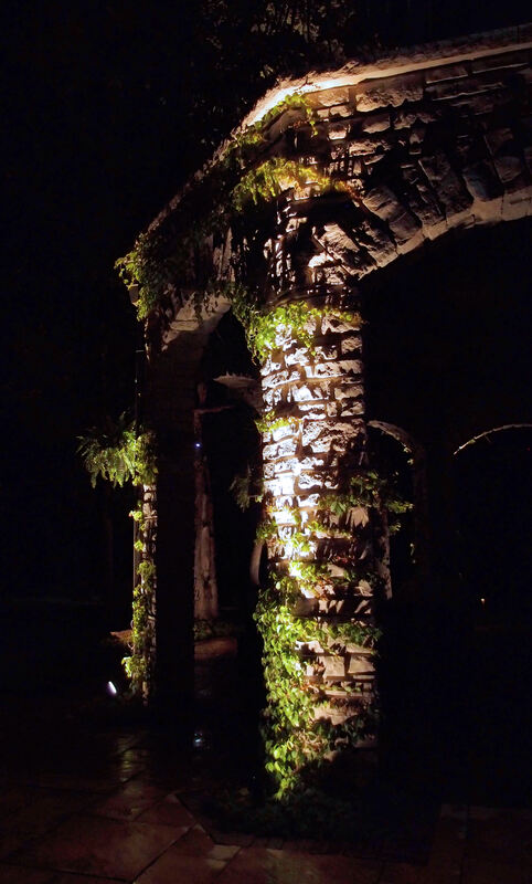 stone pillar lit by floodlights at night