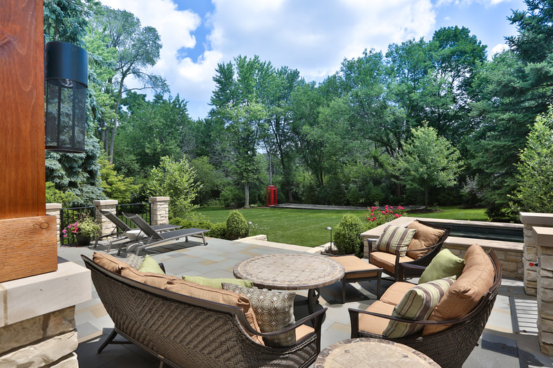 outdoor patio furniture and landscape in background
