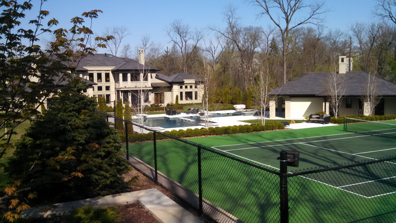 private tennis court in large home's backyard