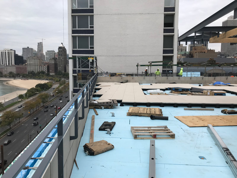 construction on a rooftop with traffic below