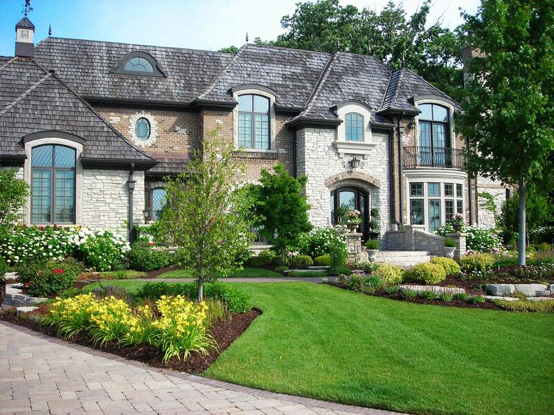 wide shot of gorgeous home and manicured lawn