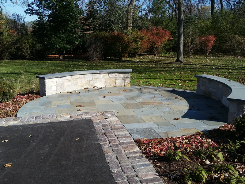 circular stone area with benches in large back yard