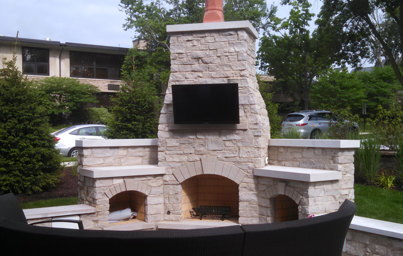 backyard fireplace and chimney with tv mounted to it