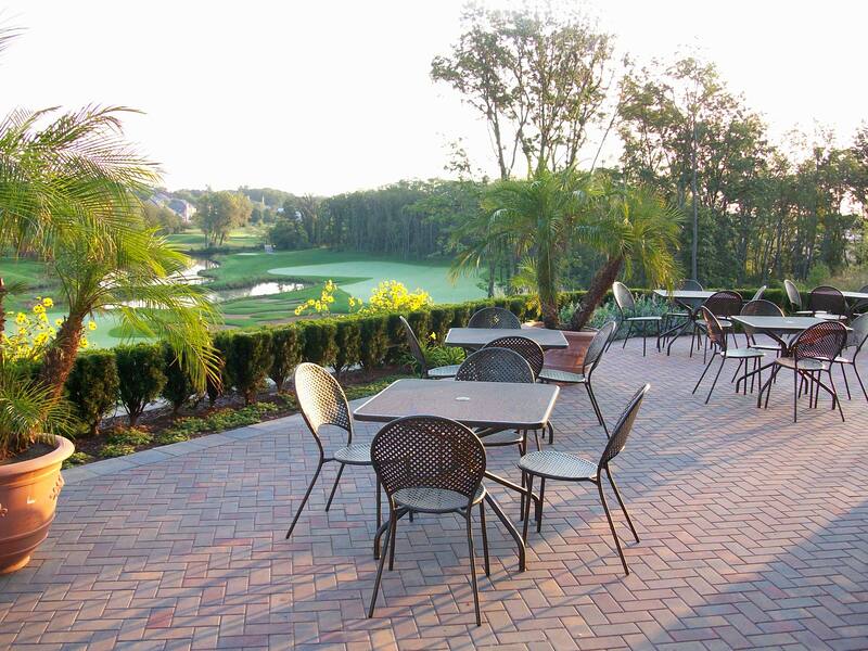 back patio at sunset with furniture and view of golf course in background